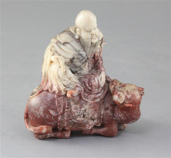 A Chinese chickens blood soapstone group of Shaolao riding a buffalo, 18th century, 13cm high, 12cm long, small losses